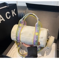 Detail of canvas cylinder bag with colorful woven straps and a round coin purse attached - Patchwork White
