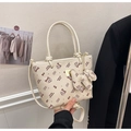 Close-up of beige crossbody bucket bag with cartoon cat print and faux leather texture - Beige Style (With Charm)
