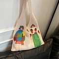 Off-white knitted tote bag featuring colorful cartoon embroidery and soft texture - White