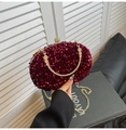 Close-up of sparkling burgundy sequin evening clutch bag with gold handle and jewel clasp - Style 2 Red