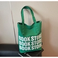 Minimalist green canvas tote bag with white Book Store lettering and dual handles - Green