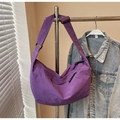 Detail of purple nylon crescent tote bag showing smooth fabric texture and wide shoulder strap - Purple
