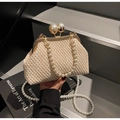 Detail of woven straw bag featuring large pearl clasp and elegant pearl shoulder strap - Off-white