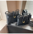 Detailed view of black matte leather shoulder bag with woven strap and gold metal buckle - Large / Black