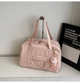 Detail of pink canvas travel bag with top zipper and plush monster charm decoration - With Charm / Pink