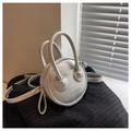 Detail of silver round handbag in lychee pattern PU leather with twin handles - Off White