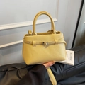 Bright yellow pebbled leather bucket bag with top handles and adjustable shoulder strap - Yellow