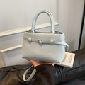 Light blue lychee pattern leather bucket bag with decorative buckle strap and top handle - Blue
