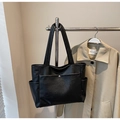 Detail view of black PU leather tote bag with side pockets and silver magnetic button pocket - Black