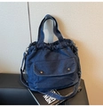 Detail of dark blue denim drawstring tote bag with vintage metal buckle and long strap - Dark Blue