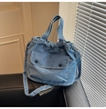 Navy blue denim drawstring tote bag with buttoned front pocket and adjustable strap - Denim Blue