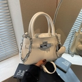 White lychee pattern leather bucket bag with silver lock and chain strap accessory - Off-white
