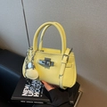 Fashionable bright yellow bucket bag with lychee texture and heart charm detail - Yellow