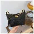 Detail of black quilted leather shoulder bag featuring gold chain and turn-lock closure - Black