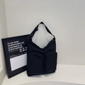 Minimalist black nylon tote bag with dual front pockets and adjustable shoulder strap - Black