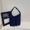 Puffy dark blue nylon crossbody bag with large front pockets and adjustable strap - Blue