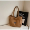 Brown canvas tote bag with large front pocket and blue TCT embroidery logo - Caramel color