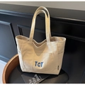 Beige canvas tote bag with blue TCT embroidery and large front pocket detail - Beige Grey
