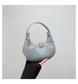 Close-up of light blue heart-shaped handbag with woven texture and gold hardware details - Blue