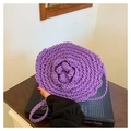 Detailed close-up of a handmade purple crochet round crossbody bag with 3D flower design - Purple