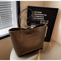 Detail of dark brown woven leather texture on a minimalist large capacity tote bag - Coffee