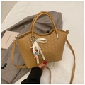 Detail of light brown woven tote bag featuring a white bow and cute cartoon pendant - With Pendant / Khaki