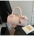 Detail view of pink Boston bag with silver padlock and leather handle straps - Pink