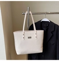 Detail of beige tote bag showing twill woven texture and rectangular metal logo tag - No Pendant / White