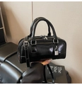 Close-up of a glossy black Boston bag with silver hardware and decorative metal lock - Black