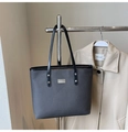 Detail of grey woven texture tote bag with black handles and silver metal nameplate - No Pendant / Black