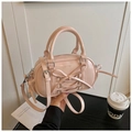 Dettaglio del delicato fiocco rosa e dei cinturini incrociati sulla borsa boston chic - Rosa