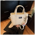 Beige mini bucket bag in lychee leather with pearl chain and cartoon doll pendant - With Charm / White
