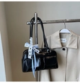 Close-up of black glossy bowling bag with front pockets and lace bow detail - Black with Pendant
