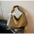 Detail of checkered tote bag featuring a white lace bow and adjustable shoulder strap - Khaki