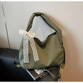 Detail of green checkered tote bag with white lace bow and adjustable shoulder strap - Green