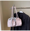 Close-up of pink shiny bowling bag featuring dual front pockets and plaid bow detail - Pink with Pendant