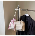 Detail of off-white PU leather shoulder bag with side pockets and a pink plaid bow charm - White with Pendant