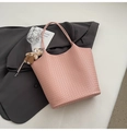 Pink woven bucket handbag with teddy bear pendant on grey blazer background - Pink with Pendant