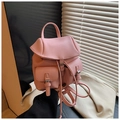 Close-up of pink lychee grain leather backpack with flap closure and buckle pockets - Pink