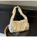 Detail of off-white pleated nylon tote bag with knotted strap on wooden chair - Off-white