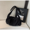 Close-up of black pleated nylon tote bag featuring a decorative knotted shoulder strap - Black