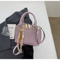 Close-up of lavender shell bag with shiny patent leather and golden zipper detail - With Pendant / Purple
