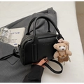 Detail of black lychee grain leather mini bag with a cute teddy bear pendant on grey blazer - Black (With Bear Pendant)