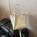 White lychee-textured bucket bag with knot handle and adjustable crossbody strap - No Pendant / Off White