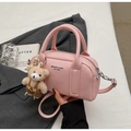 Detail view of pink litchi grain leather bowling bag with cute teddy bear charm - Pink (With Bear Charm)