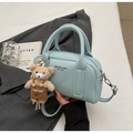 Detail of light blue bowling handbag with pebble leather texture and cute bear charm - Blue With Bear Charm