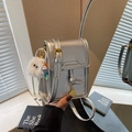 Chic silver square mobile phone bag with golden hardware and cute plush charm detail - With Charm / Silver