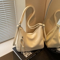 Chic hobo shoulder bag in cream white with stylish tassel and silver buckle detail - White