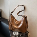 Brown faux leather hobo shoulder bag with silver hardware and tassel detail - Brown