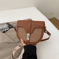 Brown patchwork saddle bag with woven texture and a geometric wide shoulder strap - Brown